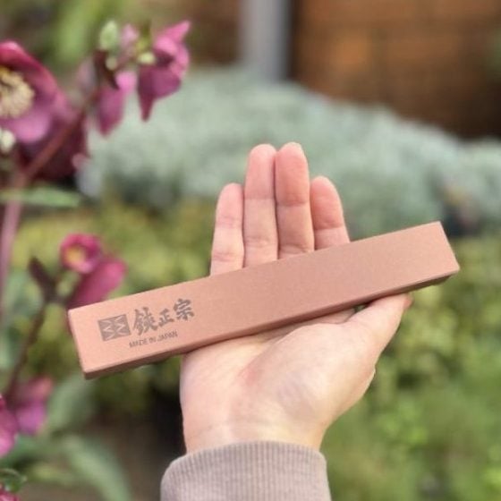 Professional 175 mm sharpening whetstone held in hand to show size