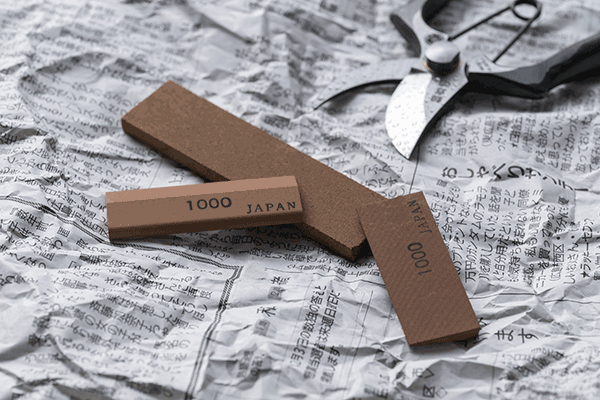 Three_Sharpening_Stones_And_Secateurs_NewsPaper